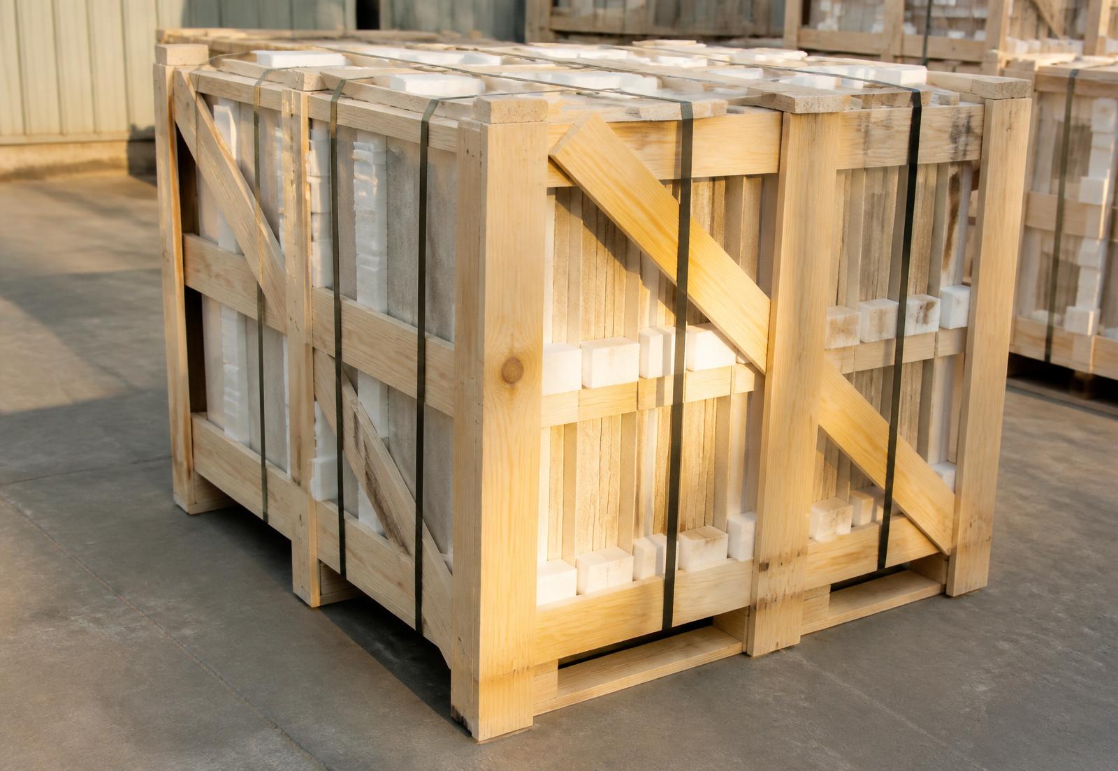 Heat-treated timber export crates loaded with limestone tiles on edge with foam separators and steel strapping
